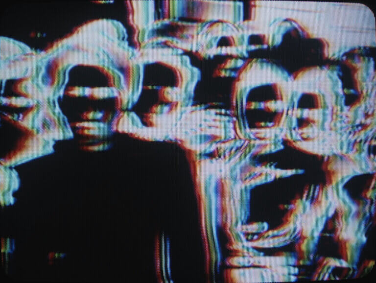 L'image négative d'un groupe de personnes sur un écran de télévision.
