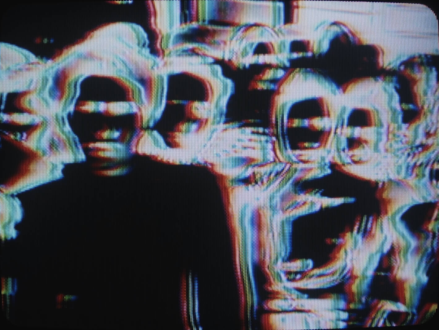 L'image négative d'un groupe de personnes sur un écran de télévision.